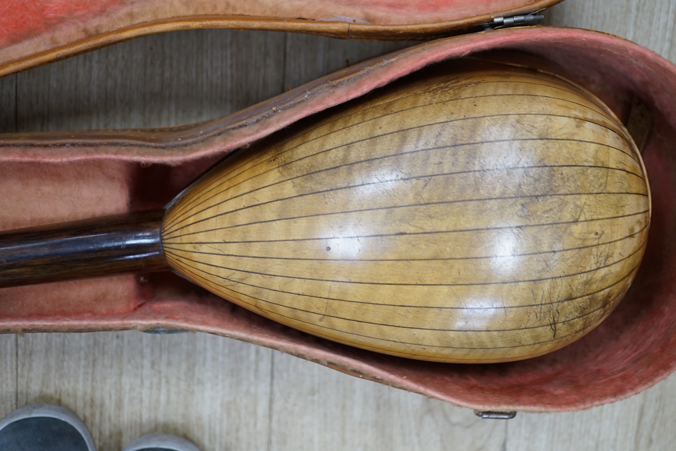 A cased Italian mandolin, labelled Domenico Maratea, and Fratelli Vinaccia, Naples, bowl backed body, length of body 30cm, with some packeted spare strings